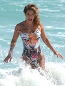 International fitness model Jennifer Nicole Lee hits the beach in a sexy one piece tiger swimsuit and shows off her inner tiger spirit at Miami Beach