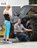 **EXCLUSIVE** Joanna Krupa rolls up to a Miami gas station to have a very pleased looking mechanic check look over her tires