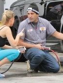 **EXCLUSIVE** Joanna Krupa rolls up to a Miami gas station to have a very pleased looking mechanic check look over her tires