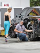 **EXCLUSIVE** Joanna Krupa rolls up to a Miami gas station to have a very pleased looking mechanic check look over her tires