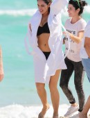 Kelly Brook rides a bicycle barefoot between photo shoot locations in Miami