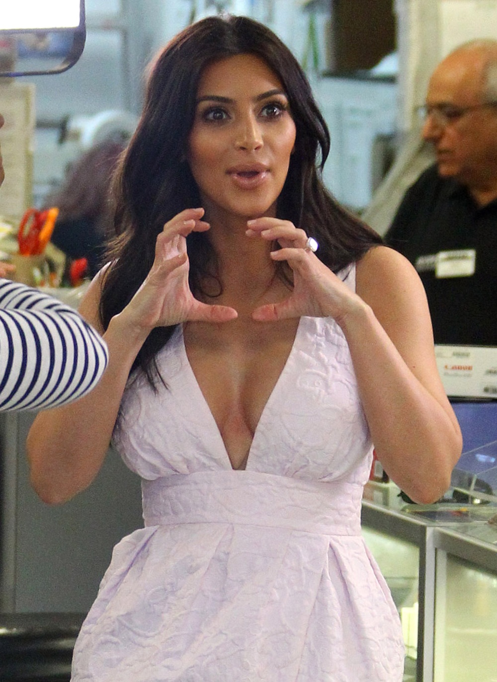Kim Kardashian cuts a triumphant figure in plunging dress as she shops for camera gear in Calabasas