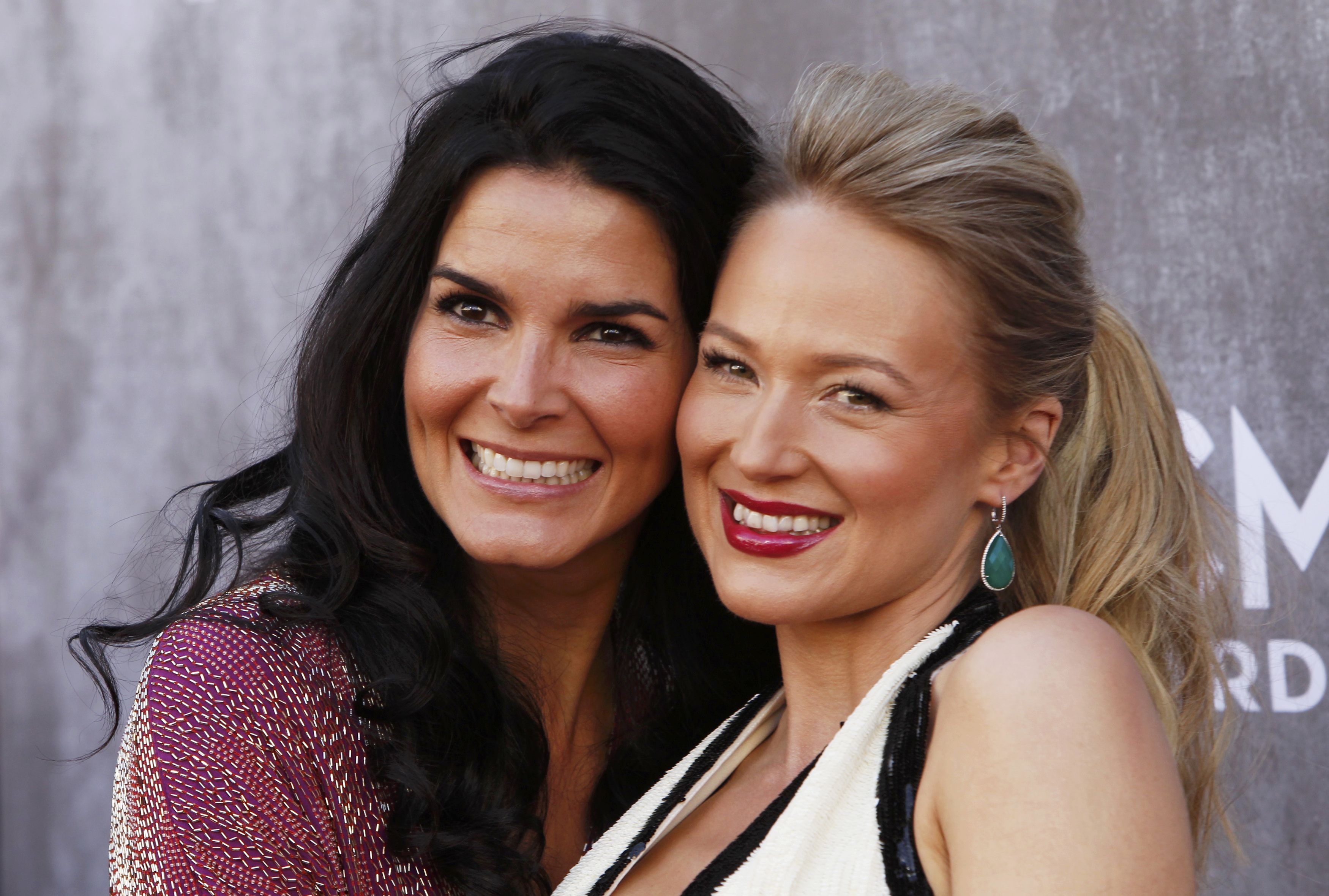 Angie Harmon and musician Jewel pose at the 49th Annual Academy of Country Music Awards in Las Vegas