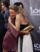 Angie Harmon and musician Jewel hug as they arrive at the 49th Annual Academy of Country Music Awards in Las Vegas