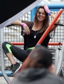 Brooke Burke-Charvet shows off her toned figure while shooting a new Sketchers advertisement at an outdoor gym in Los Angeles