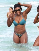 Serena Williams shows off her fit body as she takes a dip in the ocean with a friend on Miami Beach