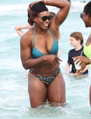 Serena Williams shows off her fit body as she takes a dip in the ocean with a friend on Miami Beach
