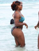 Serena Williams shows off her fit body as she takes a dip in the ocean with a friend on Miami Beach