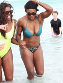 Serena Williams shows off her fit body as she takes a dip in the ocean with a friend on Miami Beach