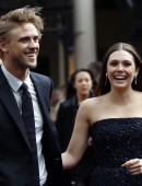 Cast member Elizabeth Olsen and her fiance Boyd Holbrook attend the Godzilla Premiere in central London