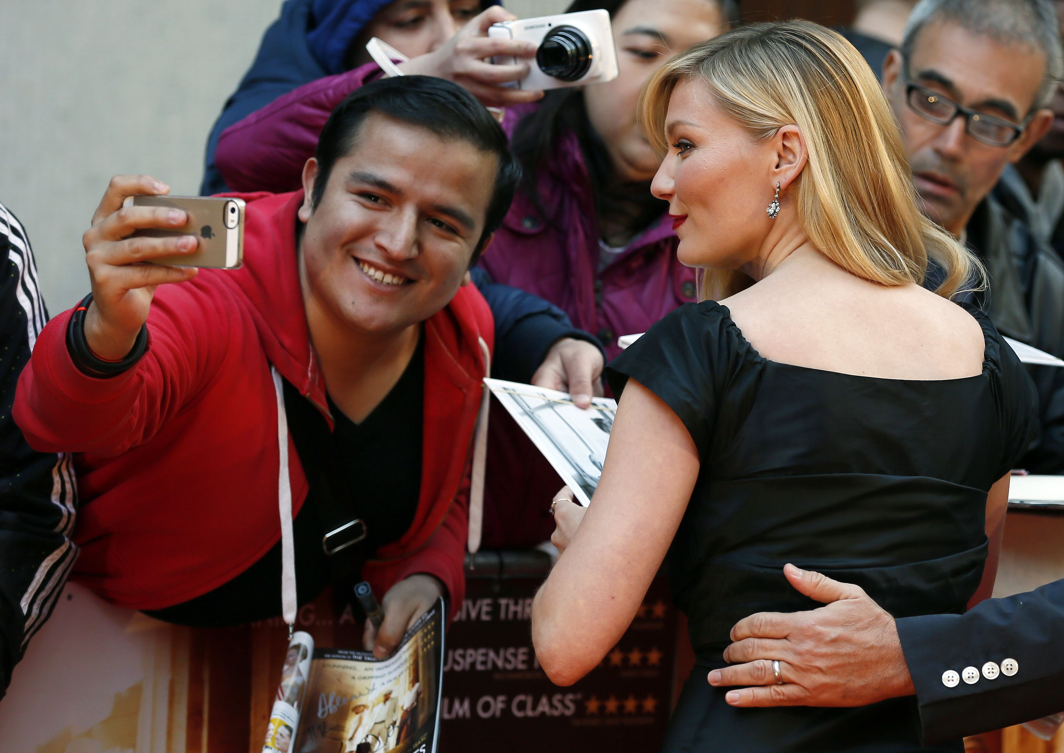 Actress Dunst poses for a photograph as she arrives for the British premiere of 'The Two Faces of January' at the Curzon Mayfair in London