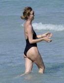 Eva Herzigova stuns in a one-piece black bathing suit as she plays volleyball on the beach with boyfriend Gregorio Marsiaj and friends in Porto Cervo