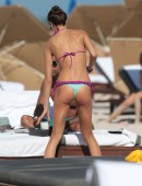 Brazilian model Julia Pereira wears a tiny ruffled bikini as she soaks up the sun on Miami Beach