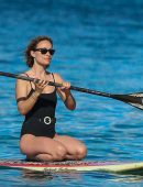 Olivia Wilde in Black Swimsuit Surfing in Hawaii