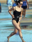Olivia Wilde in Black Swimsuit Surfing in Hawaii