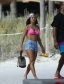 Karrueche Tran shows off her bikini body in a pink bikini as she hits the beach with boyfriend Victor Cruz in Miami