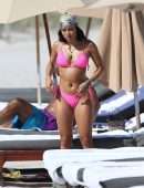 Karrueche Tran shows off her bikini body in a pink bikini as she hits the beach with boyfriend Victor Cruz in Miami
