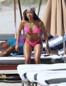 Karrueche Tran shows off her bikini body in a pink bikini as she hits the beach with boyfriend Victor Cruz in Miami