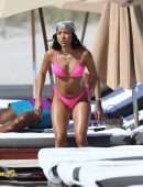 Karrueche Tran shows off her bikini body in a pink bikini as she hits the beach with boyfriend Victor Cruz in Miami