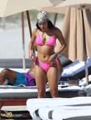 Karrueche Tran shows off her bikini body in a pink bikini as she hits the beach with boyfriend Victor Cruz in Miami