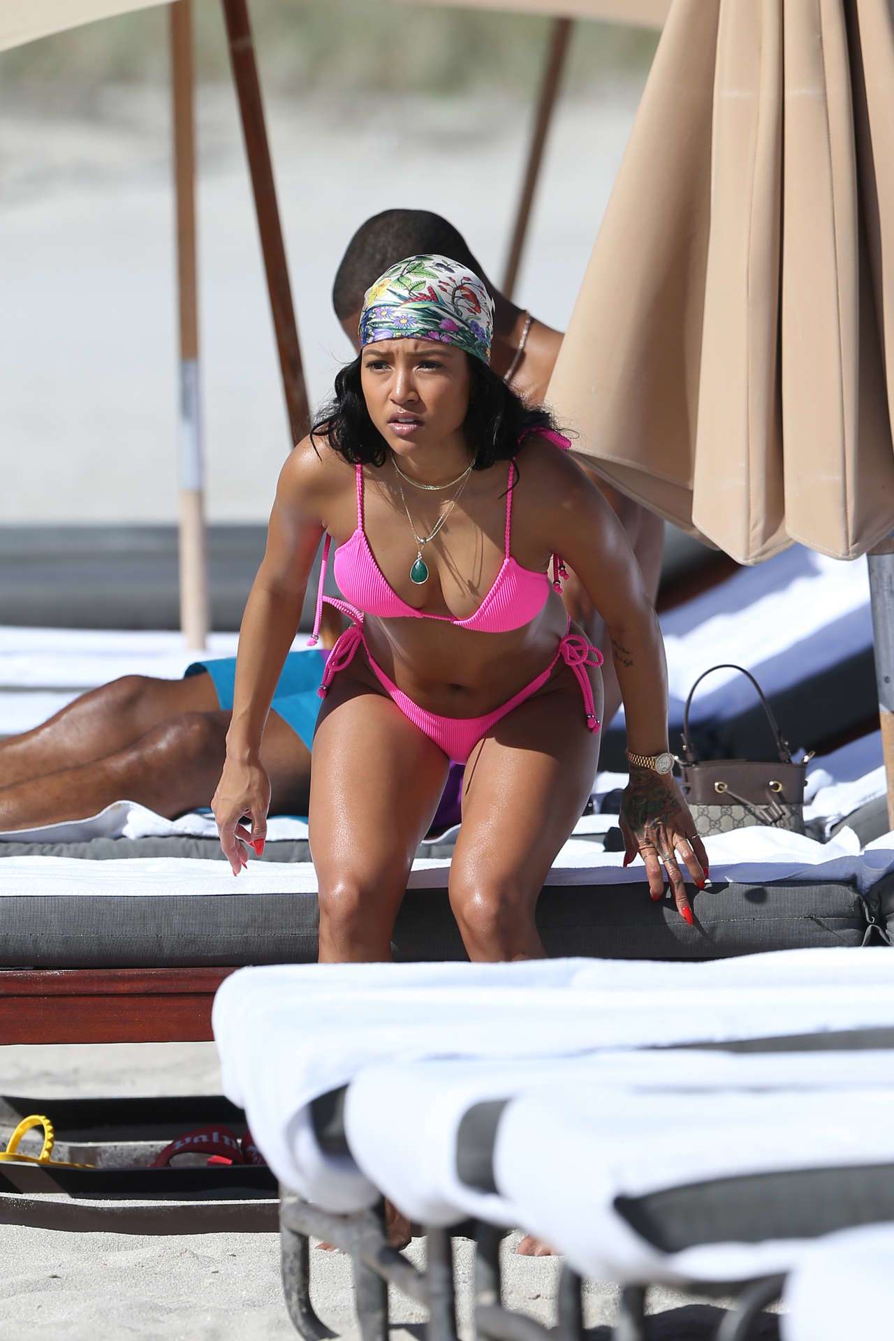 Karrueche Tran shows off her bikini body in a pink bikini as she hits the beach with boyfriend Victor Cruz in Miami
