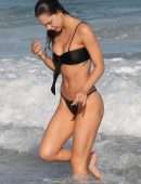Alexis Ren in Black Bikini at a Beach in Tulum