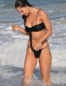 Alexis Ren in Black Bikini at a Beach in Tulum