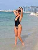 Chloe Goodman in Black Swimsuit on the Beach in Dubai