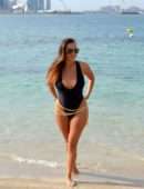 Chloe Goodman in Black Swimsuit on the Beach in Dubai