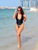 Chloe Goodman in Black Swimsuit on the Beach in Dubai