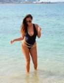 Chloe Goodman in Black Swimsuit on the Beach in Dubai