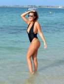 Chloe Goodman in Black Swimsuit on the Beach in Dubai