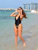 Chloe Goodman in Black Swimsuit on the Beach in Dubai