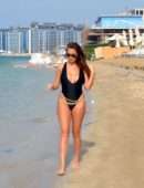 Chloe Goodman in Black Swimsuit on the Beach in Dubai
