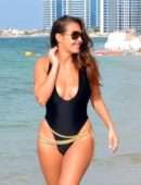 Chloe Goodman in Black Swimsuit on the Beach in Dubai