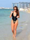 Chloe Goodman in Black Swimsuit on the Beach in Dubai