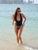 Chloe Goodman in Black Swimsuit on the Beach in Dubai