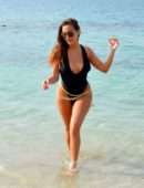 Chloe Goodman in Black Swimsuit on the Beach in Dubai