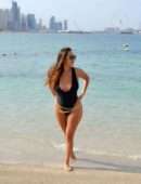 Chloe Goodman in Black Swimsuit on the Beach in Dubai