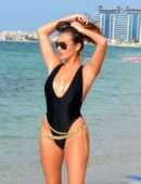 Chloe Goodman in Black Swimsuit on the Beach in Dubai