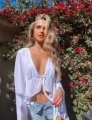 Anne Winters in White Blouse and Denim Shorts