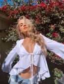 Anne Winters in White Blouse and Denim Shorts