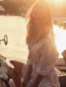 Alexis Ren Braless in a Sunset Photoshoot on a Scooter