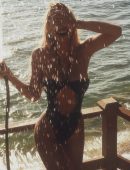 Alexis Ren Booty in a Black Thong Swimsuit Photoshoot