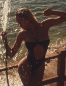 Alexis Ren Booty in a Black Thong Swimsuit Photoshoot
