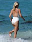 Claire Holt in One-piece Swimsuit as she takes a Dip in the Ocean in Miami