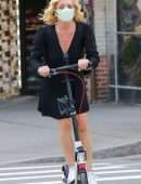 Jane Krakowski in Short Dress Riding a Scooter in NYC