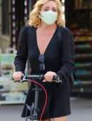 Jane Krakowski in Short Dress Riding a Scooter in NYC