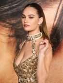 Lily James Cleavage in a Golden Dress at “Pam & Tommy” Finale Premiere in Los Angeles