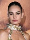 Lily James Cleavage in a Golden Dress at “Pam & Tommy” Finale Premiere in Los Angeles